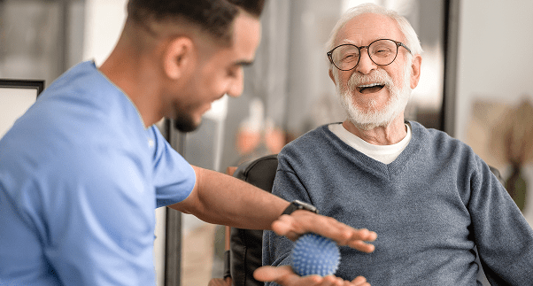 Elderly man smiling during therapy session.