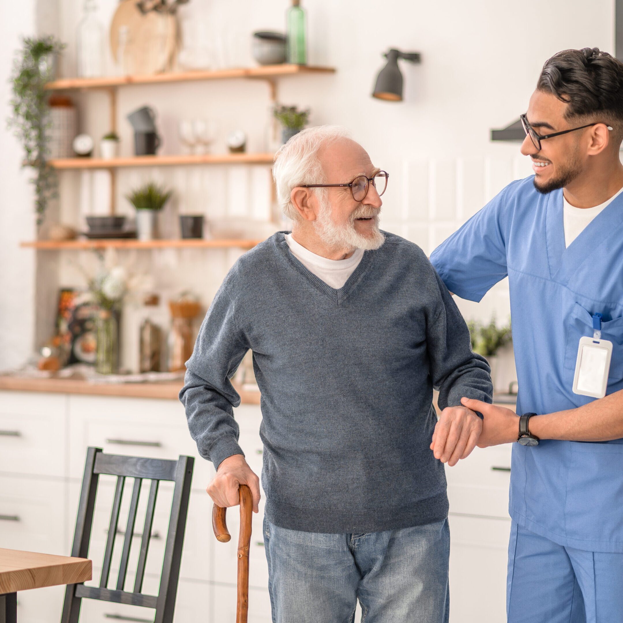 Elderly man assisted by healthcare professional.