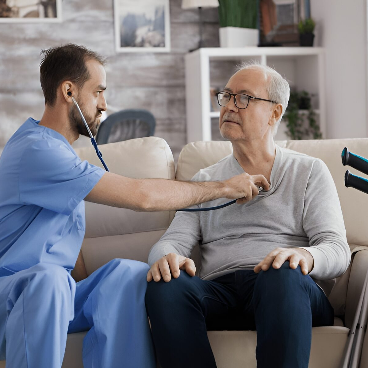 Healthcare professional examining elderly man at home.
